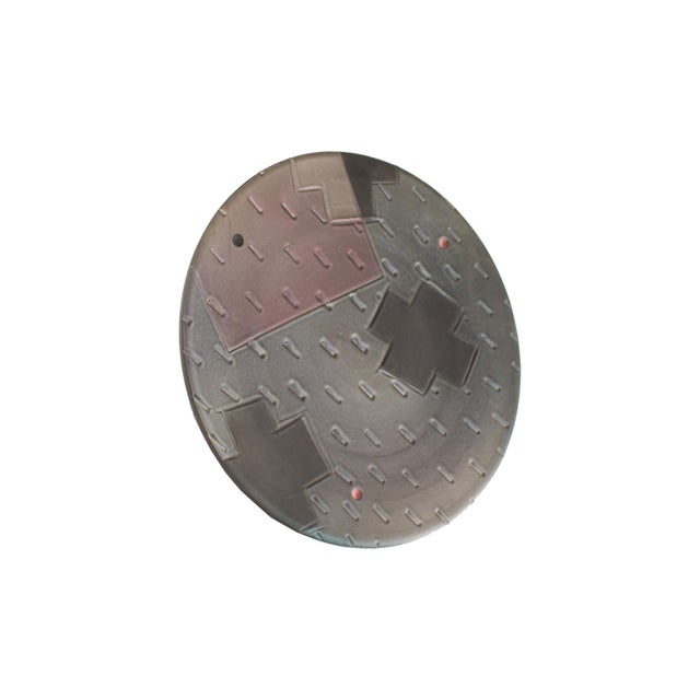 A Postmodern studio pottery wall plate by the American ceramic artist Jim Kemp (155-2013). This plate is predominantly...