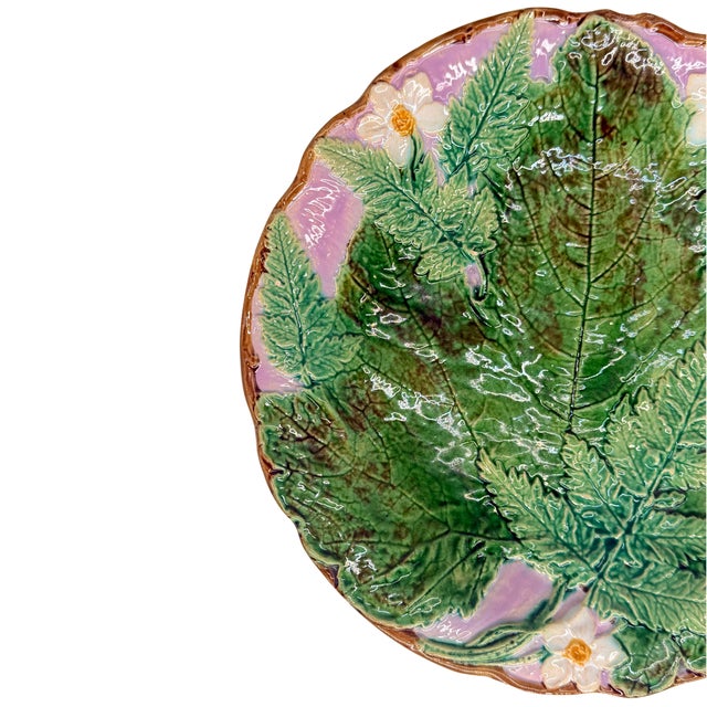 A Rare Joseph Holdcroft Majolica Footed Plate with a large green-glazed leaf with ferns and blossoms with a lavender...