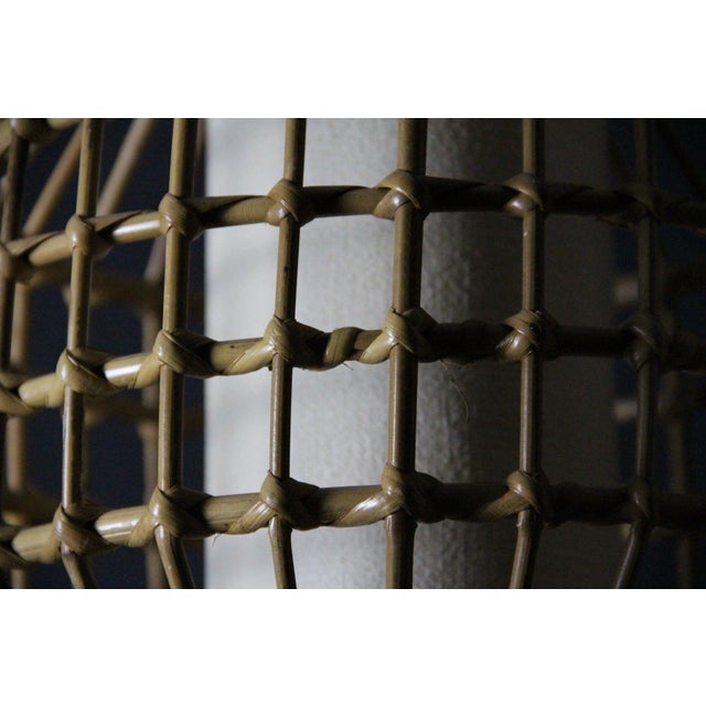 Magnificent mid-century style pendant light inspired by the french riviera, entirely crafted from hand-bent rattan and...