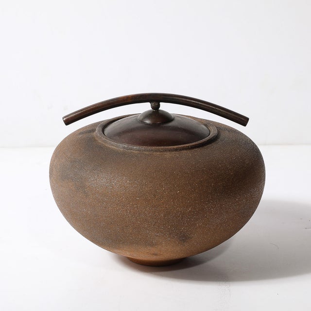 This striking modernist vessel, hand-spun from mica clay and smoke-fired, showcases the innovative artistry of American...