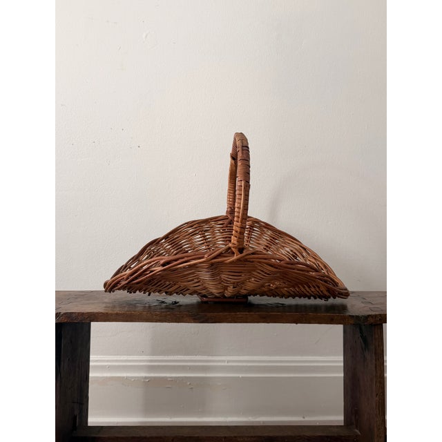 A vintage hand-woven willow flower basket made in Portugal, where basketry has been a regional craft tradition for...