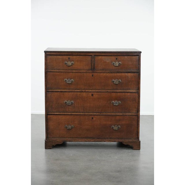We are offering this beautiful English antique oak chest of drawers/commode from the late 18th century with beautiful...