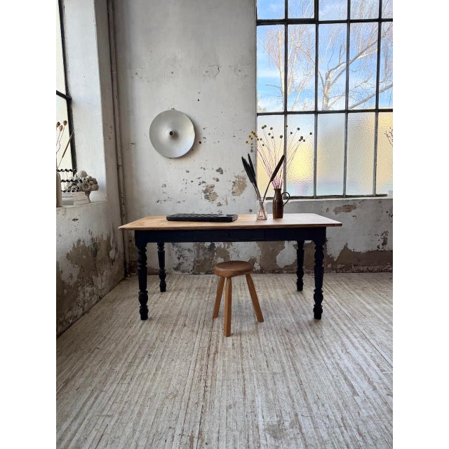 Oak farmhouse table with a turned base from the 1950s. the beautiful oak top with its mortise and tenon joints is...