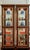 An incredible pair of Vintage faux bamboo ming base glass etagere cabinets in the style of Jasper. The cabinets are well...