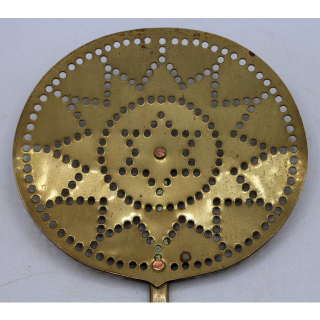 Circa 1860-80 English brass skimmer. Concentric circles & stars punch work motif. Brass rivets. Shaped handle. 21.75" x 7...