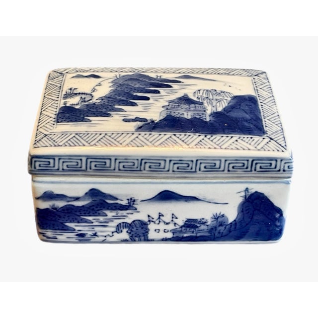 A Chinese porcelain blue and white box, decorated with traditional Asian scenery. Circa mid 20th century.