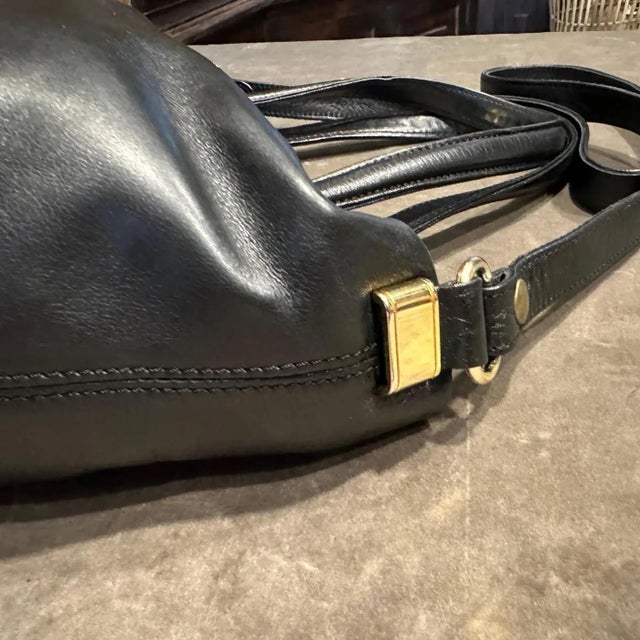Elegant 1990s Gianfranco Ferrè Black Leather & Brass Handbag Crafted from supple black leather, this elegant piece...