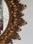 A striking mid-century giltwood sunburst mirror featuring a richly carved frame composed of radiating acanthus leaves...