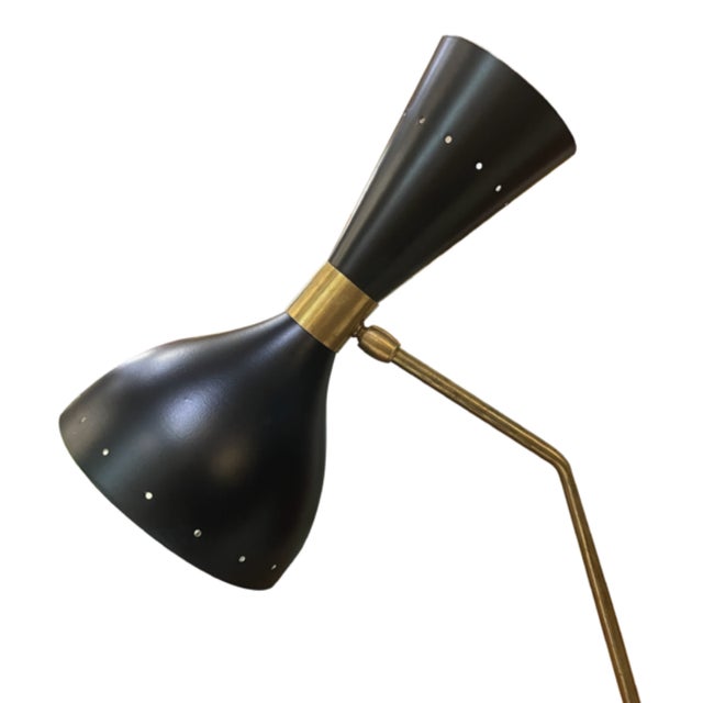 Stilnovo designer desk lamp, an original from the 1970s. Characterized by its tubular structure in gilded brass and its...