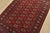 A tribal Bokhara rug hand-knotted with fine wool on a cotton foundation. This rug features rows of repeating medallions...
