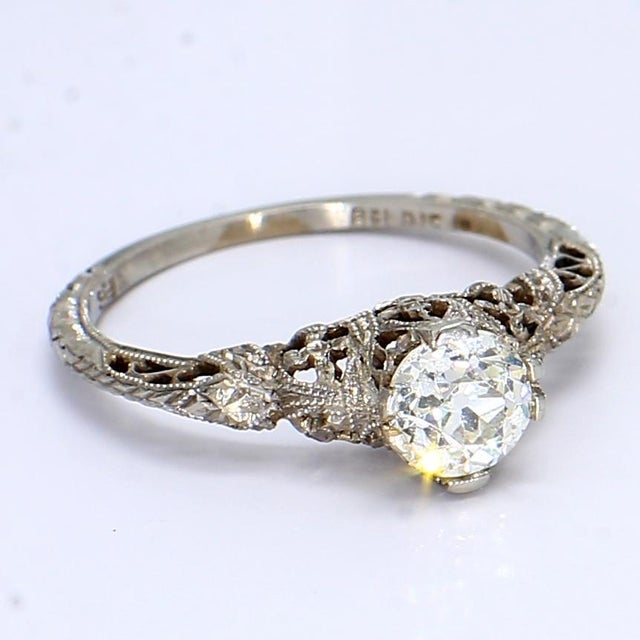 This is a lovely vintage 18k white gold ring featuring a 0.5ct old European cut center diamond rated at SI1/G. - Stone...