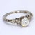 This is a lovely vintage 18k white gold ring featuring a 0.5ct old European cut center diamond rated at SI1/G. - Stone...