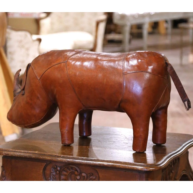 Bring charm, craftsmanship, and a touch of British wit to your interior with this mid-century leather rhinoceros,...