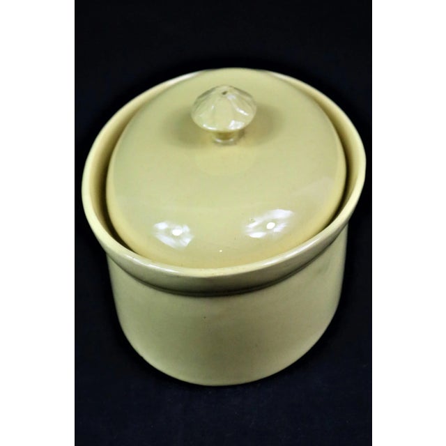 A late 19th century French yellow ware oval cassarole with a hig domed lid (perfect for Cassoulet) and an acanthus leaf...