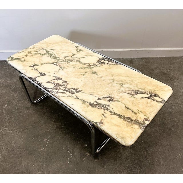 Stunning large Italian coffee table from the 1970s featuring an exceptional Calacatta Violetta marble top — one of the...