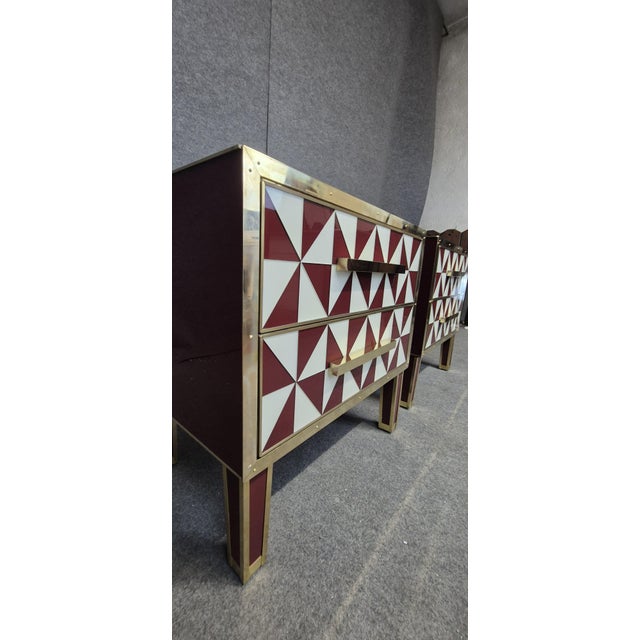 This pair of red and white Murano glass “optical” nightstands with brass trim is a stunning representation of mid-century...