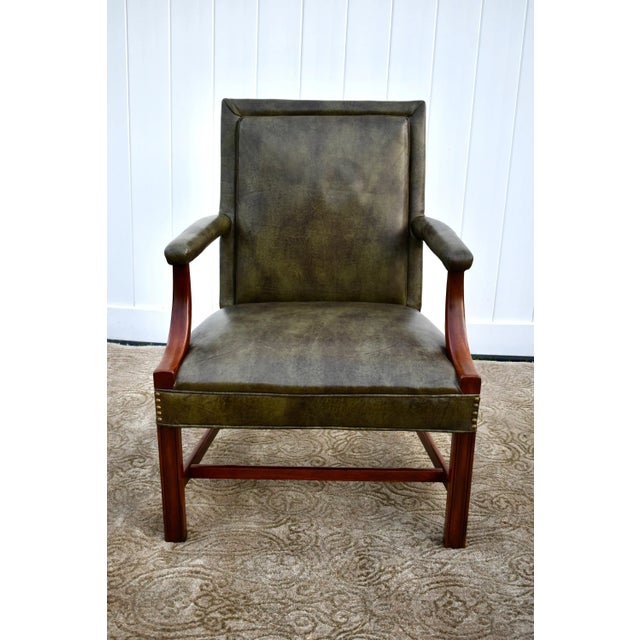 This Accent Chair has a Chippendale Style. The Frame is Mahogany with a Stretcher Base. Green Fabric Leather with Nail...