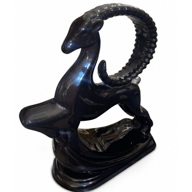 A dramatic matched pair of vintage Royal Haeger ceramic sculptures depicting stylized gazelles captured in mid-leap,...