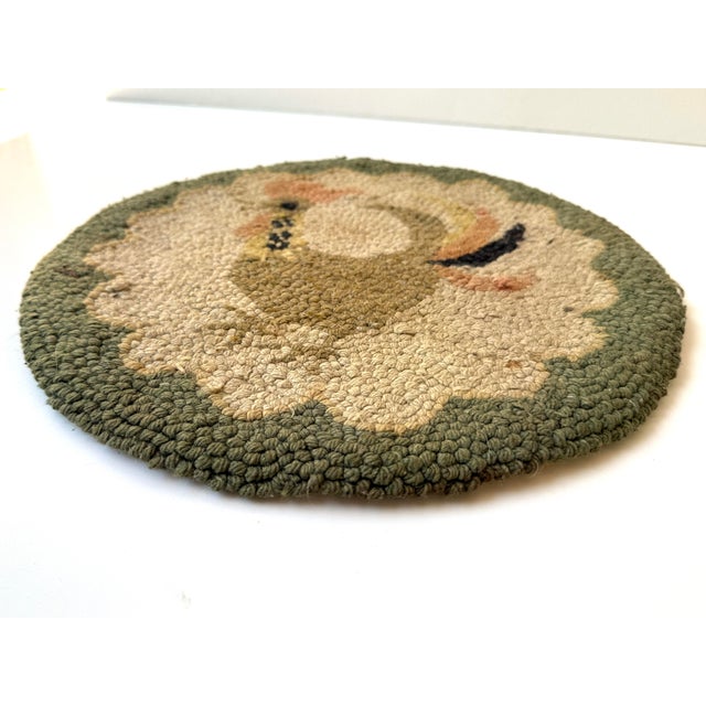 Rooster hook rug/seat cushion, hand hooked in tan, peach, black, yellow, beige, and sage green, with burlap backing. A...