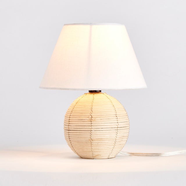 Woven in a natural cane rattan, with subtle variations in color making each one truly unique, this mini lamp is an instant...