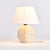 Woven in a natural cane rattan, with subtle variations in color making each one truly unique, this mini lamp is an instant...