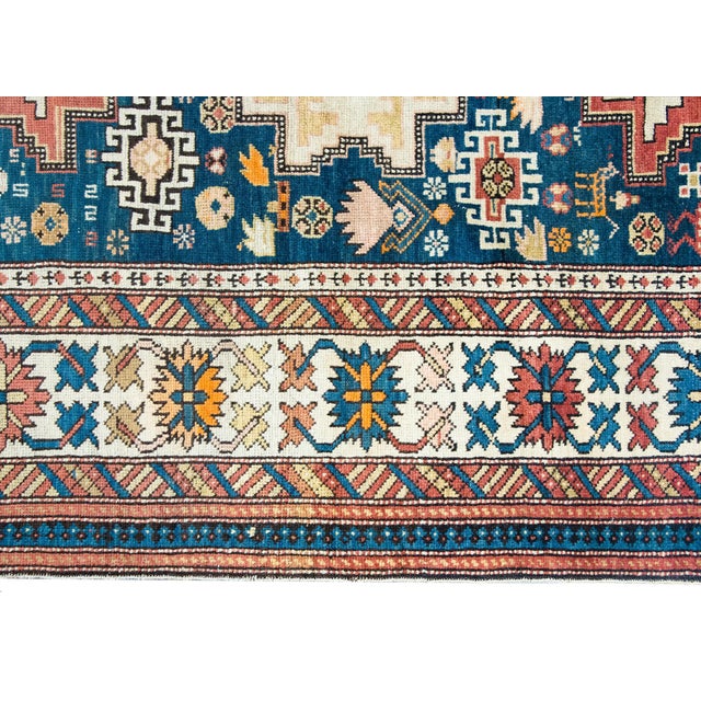 An outstanding early 20th century Persian Shriven rug with three large stylized floral medallions living amidst a field...