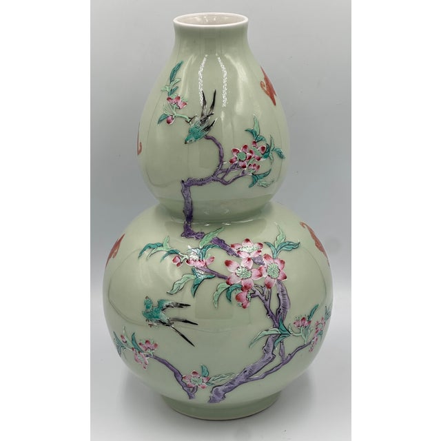 Qing Dynasty Double-Gourd Celadon Vase, a truly exceptional piece of Chinese artistry. Bearing the prestigious Qianlong...