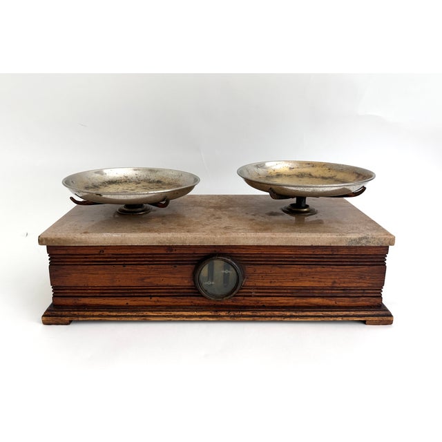 This Eastlake-style carved oak base is topped with a thick slab of marble with two metal pans stamped with Henry Troemner...