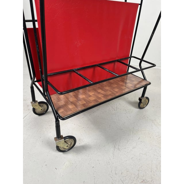 Gorgeous petite magazine rack made in the Mid 1960s. On one side there is room to place 4 bottles. The other side is a...