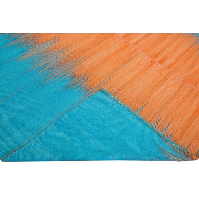 Beautiful modern Kilim flat-weave wool rug with a blue and orange field. This piece of art has a gorgeous abstract retro...