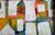 Colorful abstract cityscape in white painted and collaged by Alabama artist Kay Sasser Jacoby on cardboard, signed on...
