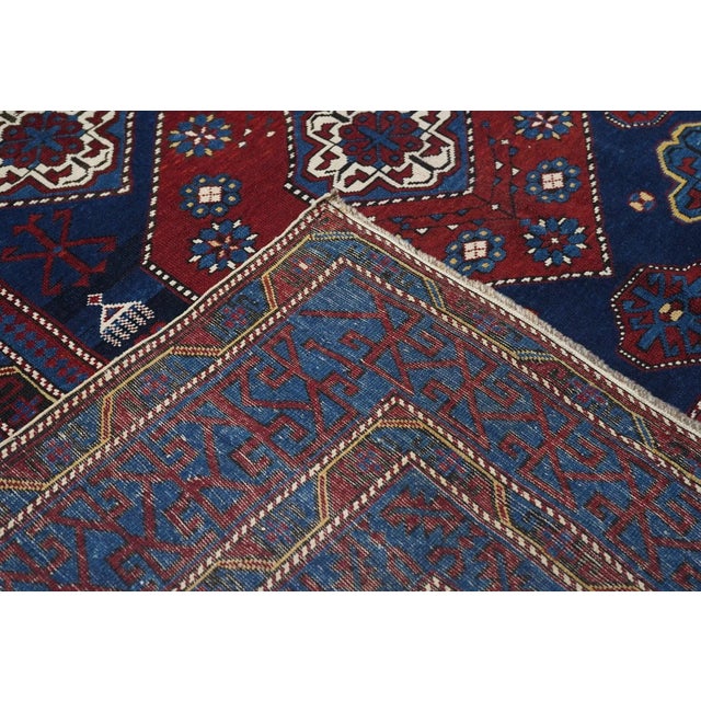 This east Caucasian well-woven scatter is basically a study in blue tones: royal blue for the field and abrashed medium-...