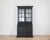 A beautifully crafted Swedish Gustavian style secretary vitrine finished in hand-painted black with a softly aged...