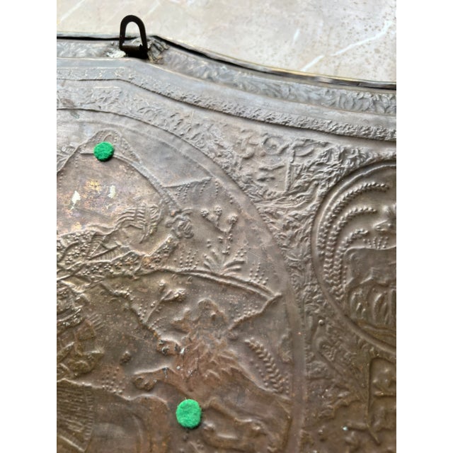 A Persian brass antique platter is a stunning decorative item with a rich history and unique aesthetic appeal, made of...