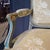 An elegant French Louis XV painted sofa settee upholstered in a neutral pale yellow silk blend, found in St. Tropez in...