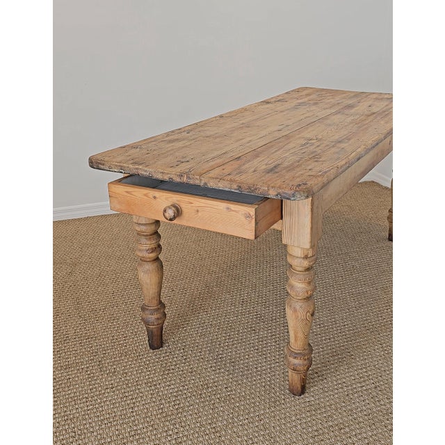 Dimensions: 71.25"W x 29.5"D x 31"H Skirt to floor: 24.25"H A beautifully rustic antique English pine dining table full of...