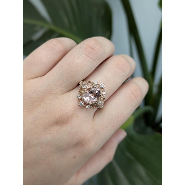 This elegant ring features a stunning 2.87ctw oval Cor de Rosa Morganite from Brazil, measuring 10x8mm and expertly heat-...