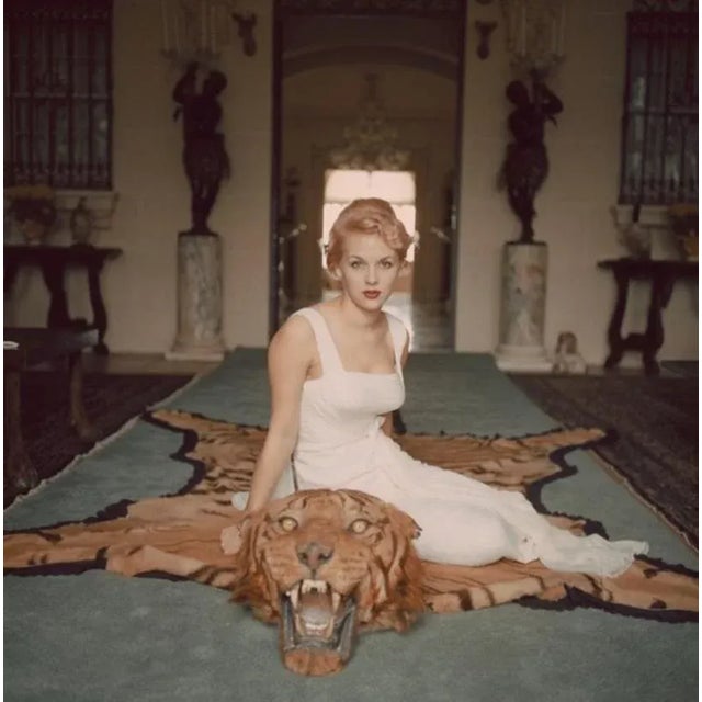 George Cameron 1959 by Slim Aarons Slim Aarons Limited Estate Edition Mrs. George (Daphne) Cameron sits on a tiger pelt in...