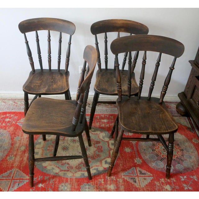 Antique set of 4 solid oak farmhouse dining chairs dating from the last part of the nineteenth century. The chairs have...