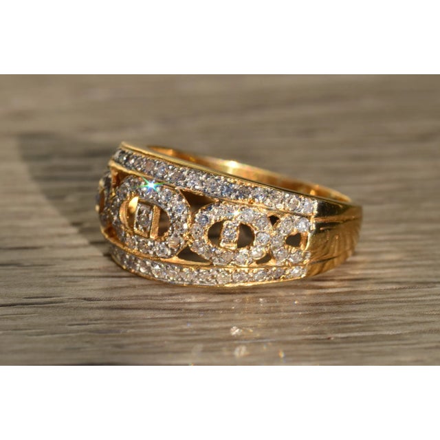 The Cardea Ladies 14K Gold and Diamond Statement Band. Crafted in 14 karat yellow gold, this ladies wide band features...