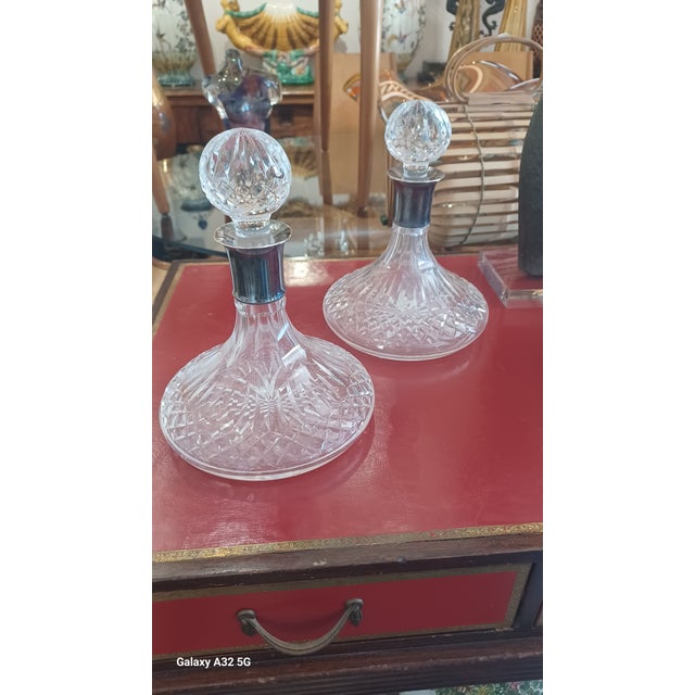 Vintage pair of Brilliant cut crystal decanters with sterling silver necks. Comes with stoppers.