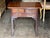 18th century English mahogany side table with a molded top and rounded front corners. Two short drawers sit over one long...
