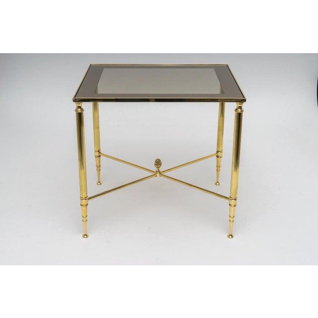 This stylish three piece set of brass nesting tables date to the 1970s and are attributed to Maison Jansen. It is...