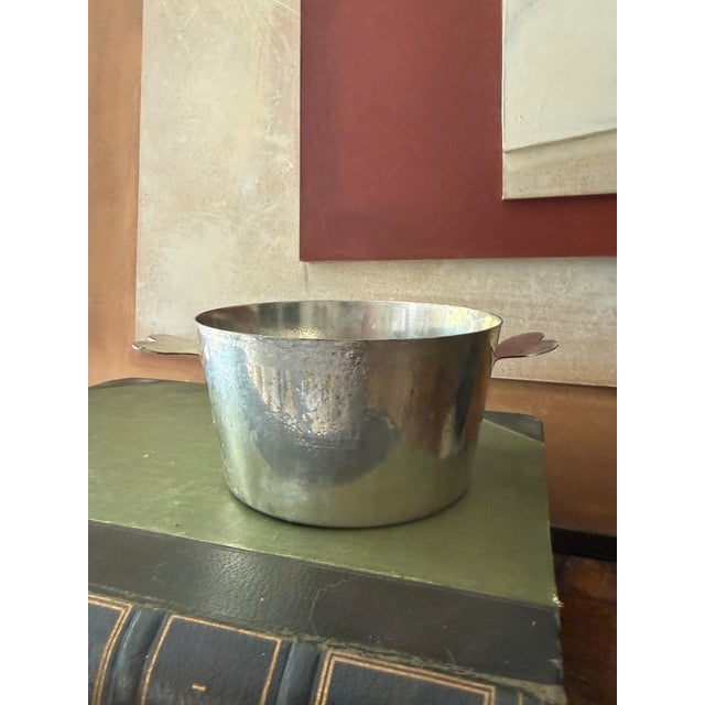 A Le Cordon Bleu French aluminum pan marked “Made in France,” featuring a simple cylindrical form with double side...