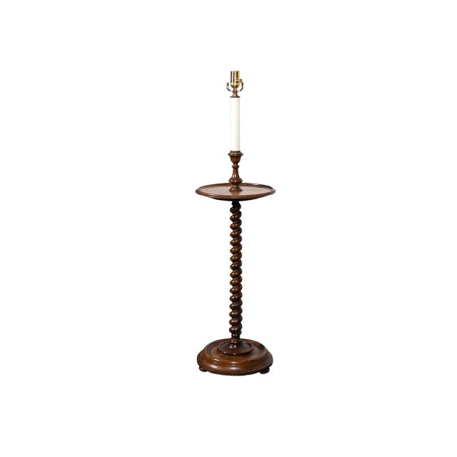 Turned walnut floor lamp with table with spiral-twist column. Round stepped base. Brass socket cup and accents.