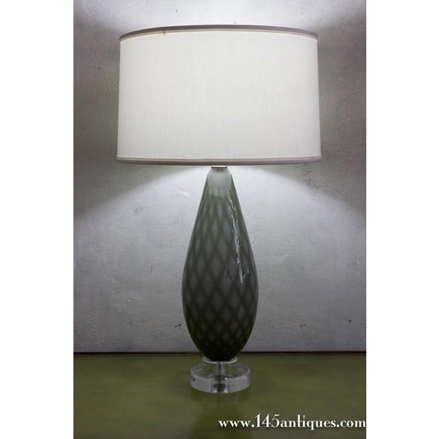 A pair of Italian Murano glass table lamps from the 1950s, featuring a molded diamond pattern in cased glass with softly...