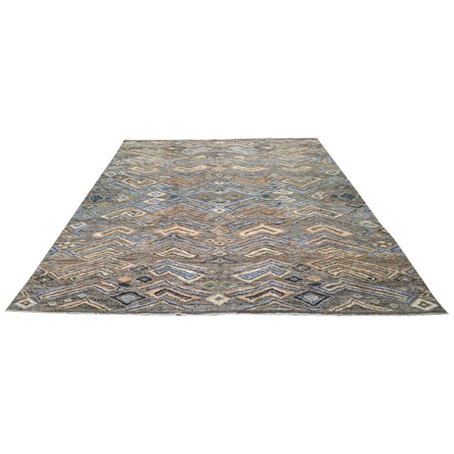 Hand-knotted with care using traditional rug making techniques, this wool rug blends timeless craftsmanship with a modern...