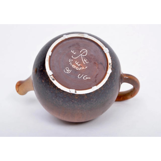 This tea pot was designed in the 1960s by Carl Harry Stålhane and manufactured in Sweden for Rörstrand. It is made from...