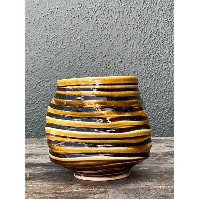 This striking studio pottery vase is a testament to Mid-Century organic design and hand-thrown artistry. The vessel...