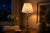 A tall and elegant vintage table lamp combining polished brass with a deep green lacquered central column, creating a...